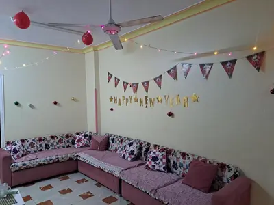 a living room with a couch and flags on the wall at Sweet Home-ممنوع للمصرين Open 24 Hour in Hurghada