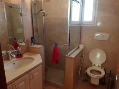 a bathroom with a shower and a toilet and a sink at Down-Town Kafr El Gouna 1-Bd Ground Floor in El Gouna