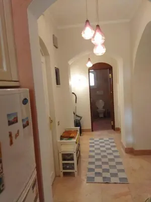 a kitchen with a checkered floor in a room at Down-Town Kafr El Gouna 1-Bd Ground Floor in El Gouna