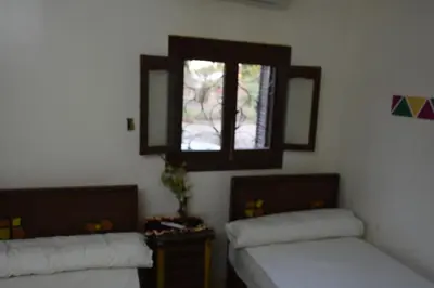 a room with two beds and a window at النبلاء جيست هاوس نوبيان اسوان in Aswan