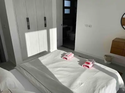 a bed with two pink phones on top of it at 3bd with a private heated pool in Sholan 2 ElGouna in Hurghada