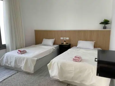 two beds in a room with pink towels on them at 3bd with a private heated pool in Sholan 2 ElGouna in Hurghada