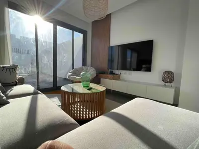 a living room with a couch and a tv at 3bd with a private heated pool in Sholan 2 ElGouna in Hurghada