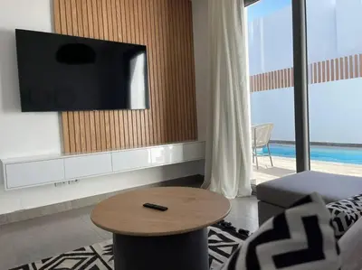 a living room with a tv and a coffee table at 2 bedroom with a private heated pool in Sholan2 in Hurghada