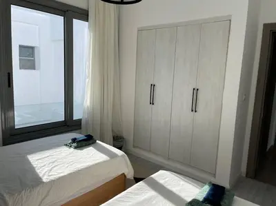 a bedroom with two beds and a large window at 2 bedroom with a private heated pool in Sholan2 in Hurghada