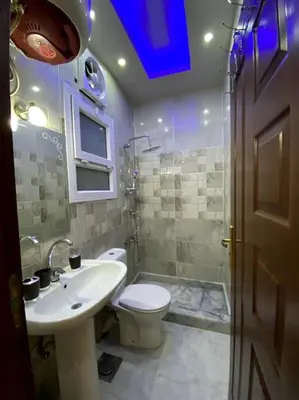 a bathroom with a sink and a toilet and a shower at F&M Home Egypt - Apartment Hurghada in Hurghada