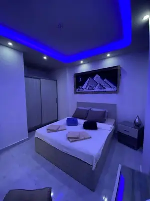 a bedroom with a large bed with a blue ceiling at F&M Home Egypt - Apartment Hurghada in Hurghada