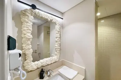 a bathroom with a large mirror and a sink at Snazzy 1BDR w Rooftop Mangroovy Free Pool & Beach Access in Hurghada