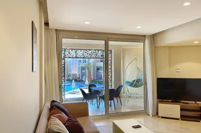 a living room with a couch and a television at Panoramic & Cushy 3BDR Mangroovy Free pool & Beach Access in Hurghada