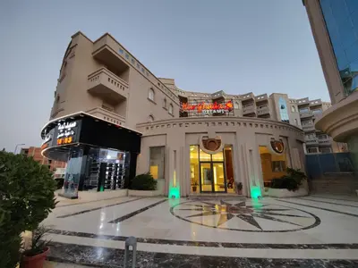 a building with green lights in the middle of a street at Sea Dreams @ Hurghada Dreams in Hurghada