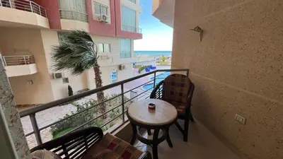 a balcony of a building with a table and chairs at Casablanca beach resort, first line with private beach and swimming pools, in Hurghada