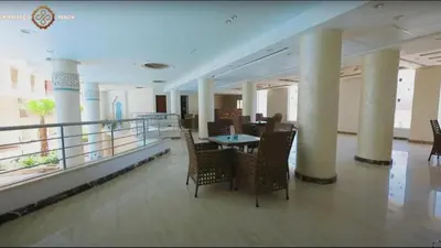 a room with chairs and a table on a balcony at Casablanca beach resort, first line with private beach and swimming pools, in Hurghada