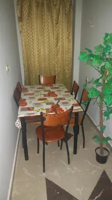 a table and chairs with a table and a plant at New ikea flat 2 in Hurghada