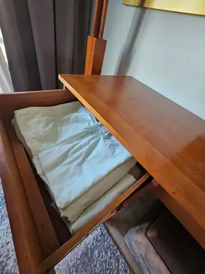 a wooden table with folded sheets on a shelf at Hurghada - Apartment Blue Lagoon in Hurghada