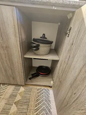 a cabinet with a bowl and a pot in it at Hurghada - Apartment Blue Lagoon in Hurghada