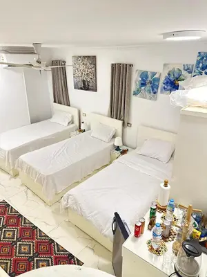 a room with two beds and a table at White House in Aswan
