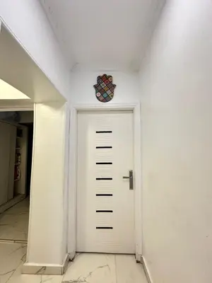 a white door in a hallway with a clock on the ceiling at White House in Aswan