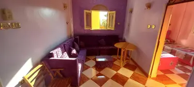 a living room with a couch and a table at Gasser Holiday Home in Aswan