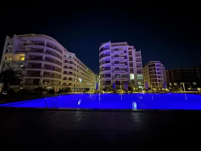 a group of buildings with blue lights in front of them at شقة احلامك علي البحر in Hurghada