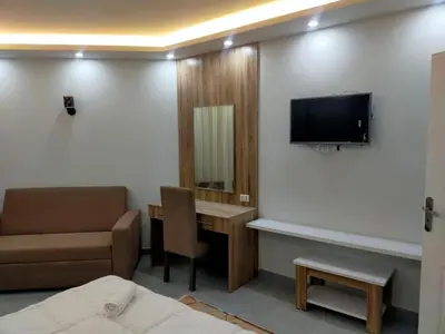 a hospital room with a bed and a tv and a desk at Orchidia in Hurghada