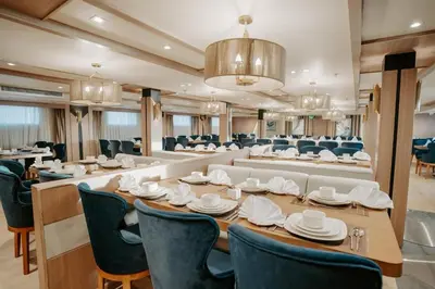a large dining room with a long table and chairs at Cleopatra Nile Cruise From Luxor 3&4 Nights Every Saturday and Monday, Thursday in Luxor