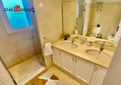 a bathroom with two sinks and a mirror at Unique 6 Bedrooms Villa 38 at White Villas El-Gouna in Hurghada