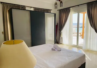 a bedroom with a bed with a purple napkin on it at Unique 6 Bedrooms Villa 38 at White Villas El-Gouna in Hurghada