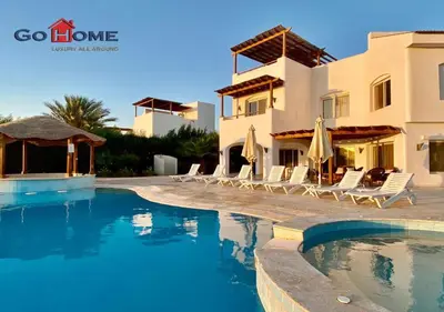 a swimming pool in front of a villa at Unique 6 Bedrooms Villa 38 at White Villas El-Gouna in Hurghada