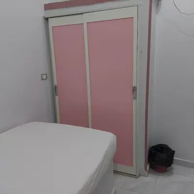 a bedroom with a bed and a pink closet at Abo Tamem Guest House in Aswan