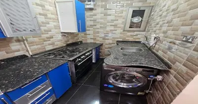 a small kitchen with a stove and a sink at Susan's Guest House and Tours in Luxor
