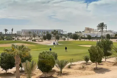 a man playing golf on a golf course at Homelike & Sunny 1 BDR Cyan El Gouna in Hurghada