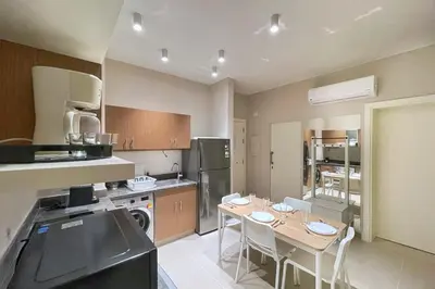 a kitchen with a table and chairs in it at Homelike & Sunny 1 BDR Cyan El Gouna in Hurghada