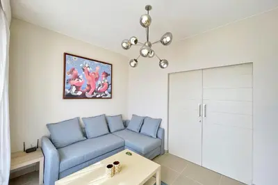 a living room with a blue couch and a table at Homelike & Sunny 1 BDR Cyan El Gouna in Hurghada