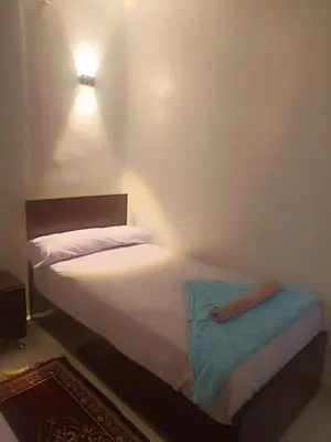 a bedroom with a bed with a blue towel on it at NUBIAN MONALIZA guest house in Aswan