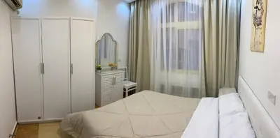 a small bedroom with a bed and a mirror at Beautiful apartment near sea 1+1 Dream Beach in Hurghada