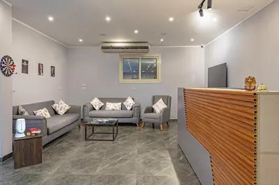 a living room with two couches and a table at Bedcoin Hostel in Hurghada