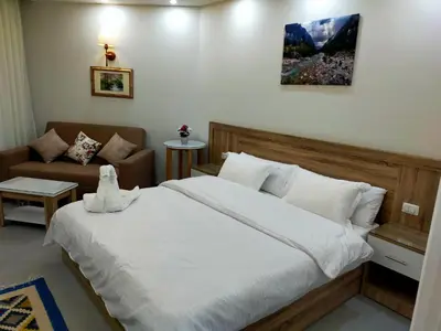 a bedroom with a large bed and a couch at شقة احلامك على البحر in Hurghada