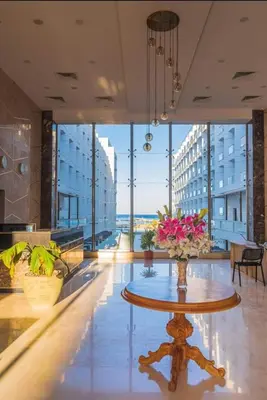 a large room with a table with flowers on it at شقة احلامك على البحر in Hurghada