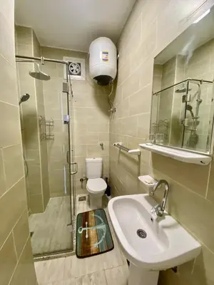 a bathroom with a shower and a sink and a toilet at 1 Bed Apartment - Balcony Pool Parking in Hurghada