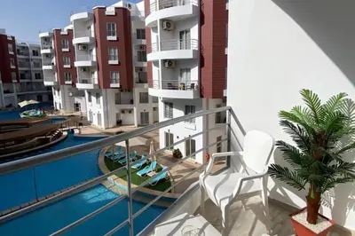 a balcony of a building with a swimming pool at 1 Bed Apartment - Balcony Pool Parking in Hurghada