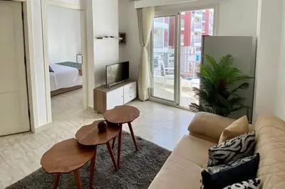a living room with a couch and a tv at 1 Bed Apartment - Balcony Pool Parking in Hurghada