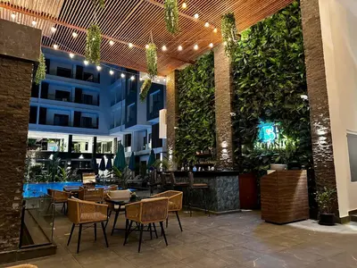 a restaurant with tables and chairs and plants at Hurghada - Apartment - Sleeps 6 - Pool - Parking in Hurghada