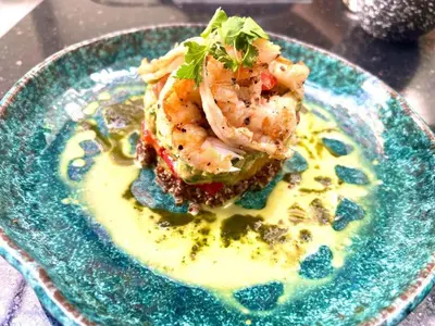 a plate of food with shrimp on top of sauce at Hurghada - Apartment - Sleeps 6 - Pool - Parking in Hurghada