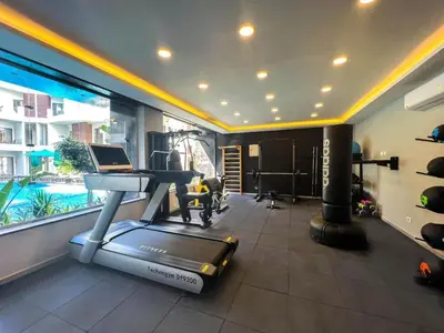 a room with a gym with a treadmill and a pool at Hurghada - Apartment - Sleeps 6 - Pool - Parking in Hurghada