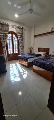 a room with two beds and a window at Moon fourteen in Luxor