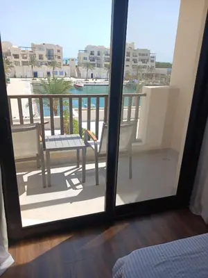 a view of a balcony with a table and chairs at Nayah Stays, Luxurious bedroom in Fanadir Marina in Hurghada