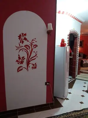 a white wall with a stencil of a tree on it at الفاوى - القصير in Quseir