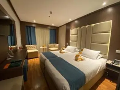 a bedroom with a large bed with two animals laying on it at Five-star Nile cruise 4 Night from Luxor to Aswan every Monday, Thursday and Saturday in Aswan