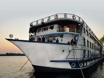 a cruise ship is docked in the water at Five-star Nile cruise 4 Night from Luxor to Aswan every Monday, Thursday and Saturday in Aswan