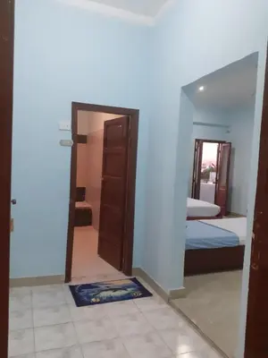 a room with a door and a bedroom with a bed at Nile Roof Hotel& Restaurant in Luxor
